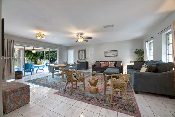 a view of a house with a yard and palm trees