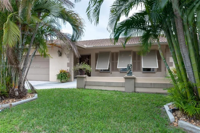 a view of a backyard with a garden and palm trees