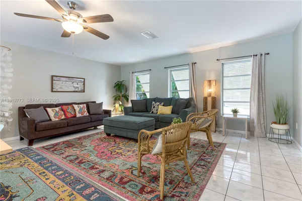 a living room with furniture and a rug