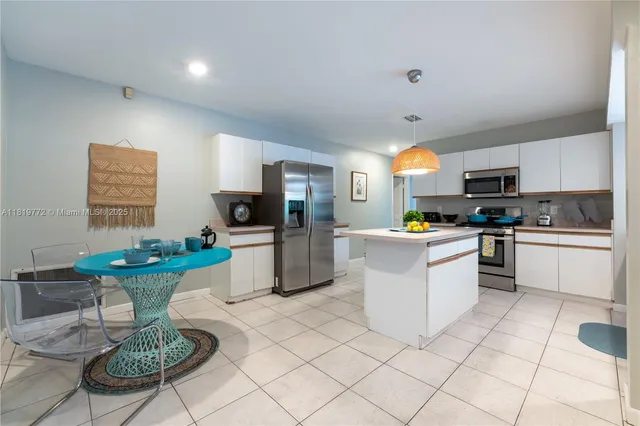 a kitchen with a sink a counter top space and appliances