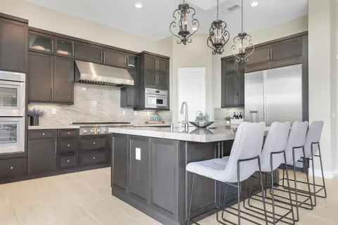a dining room with a table and chairs
