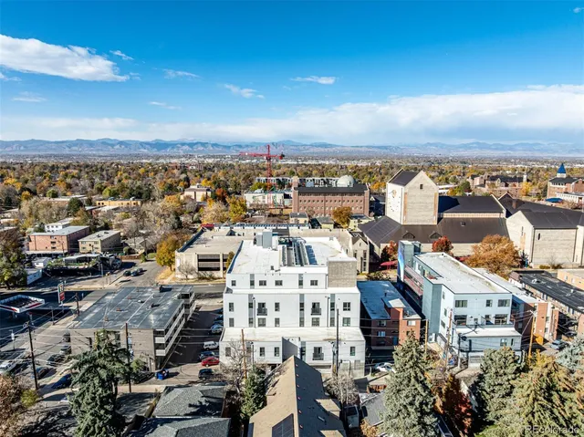 an aerial view of a building with an outdoor seating