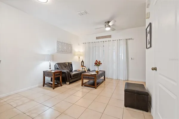a living room with furniture and kitchen view