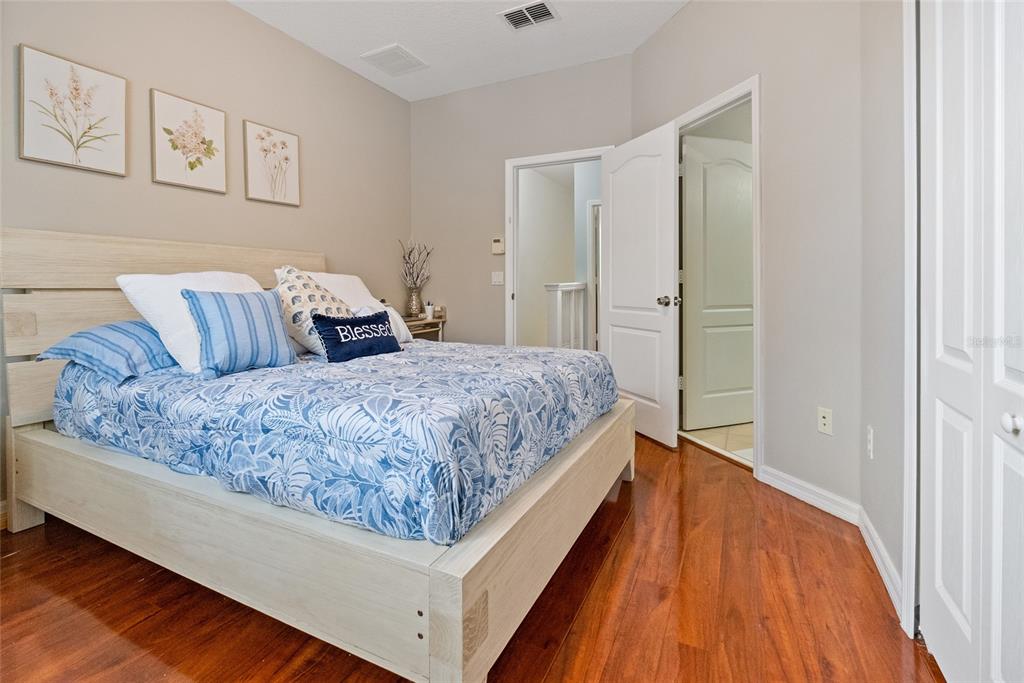 10475 Manderley Way Orlando, FL 32829 - Photo 18 of 31 a living room with a bed and a wooden floor
