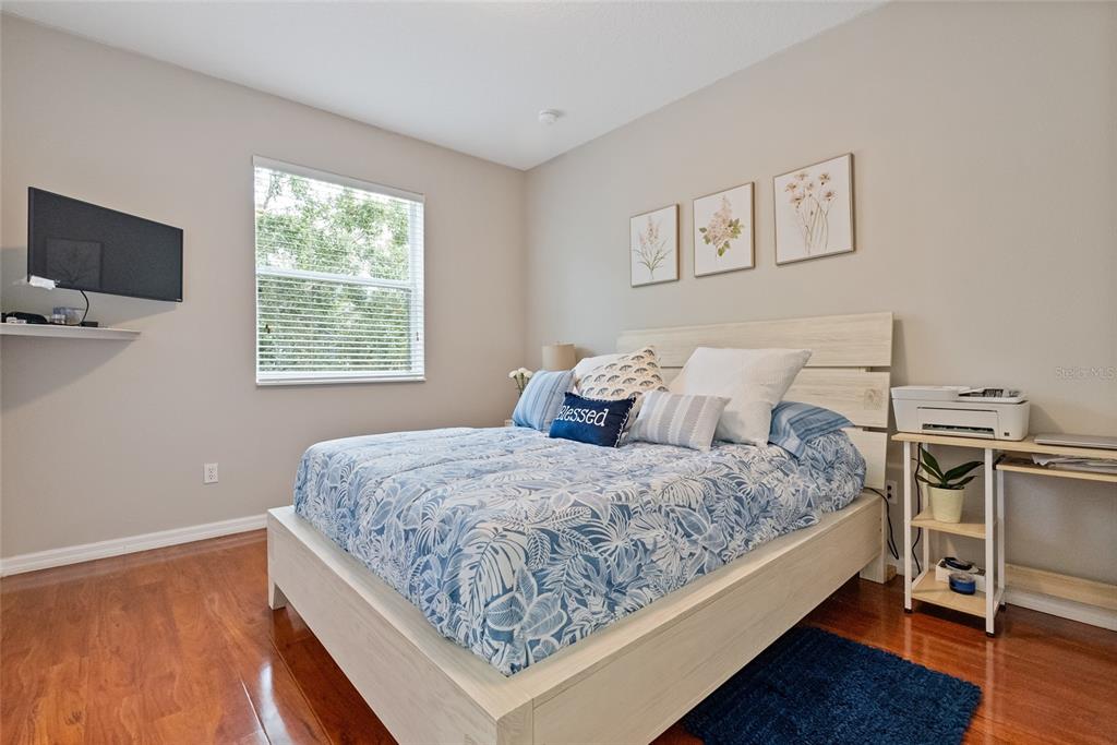 10475 Manderley Way Orlando, FL 32829 - Photo 19 of 31 a bedroom with a bed and a flat screen tv