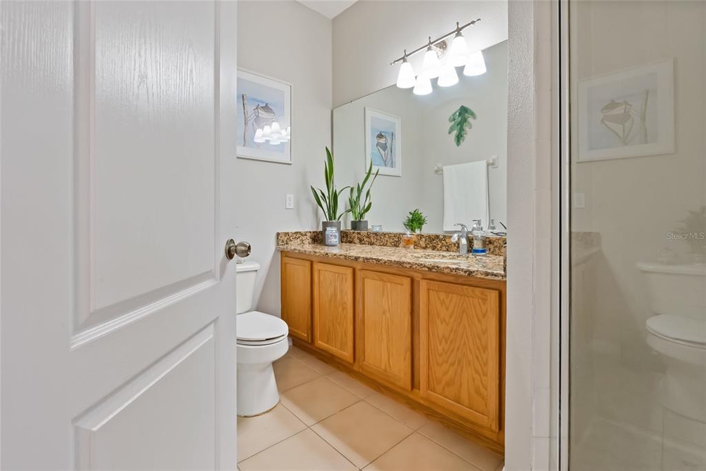 10475 Manderley Way Orlando, FL 32829 - Photo 20 of 31 a bathroom with a sink a toilet and shower