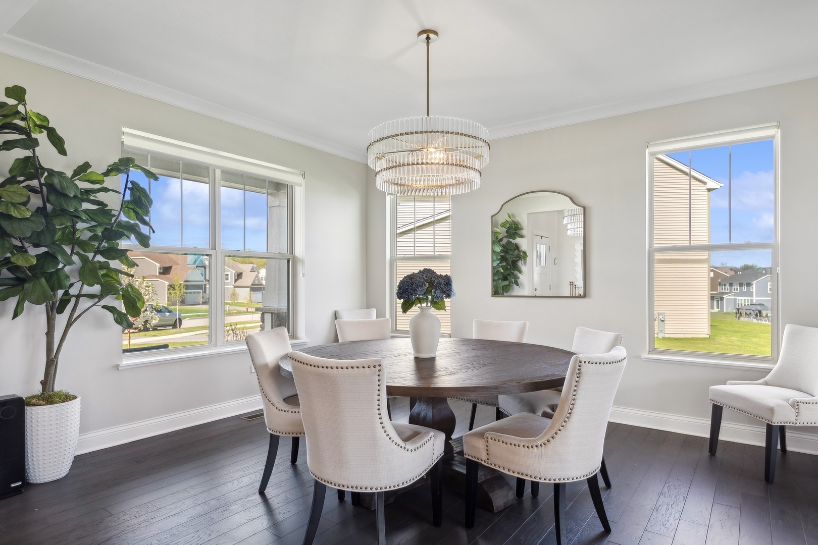 1142 Glengary Court Crystal Lake, IL 60012 - Photo 3 of 24 a dining room with wooden floor a chandelier a wooden table and chairs