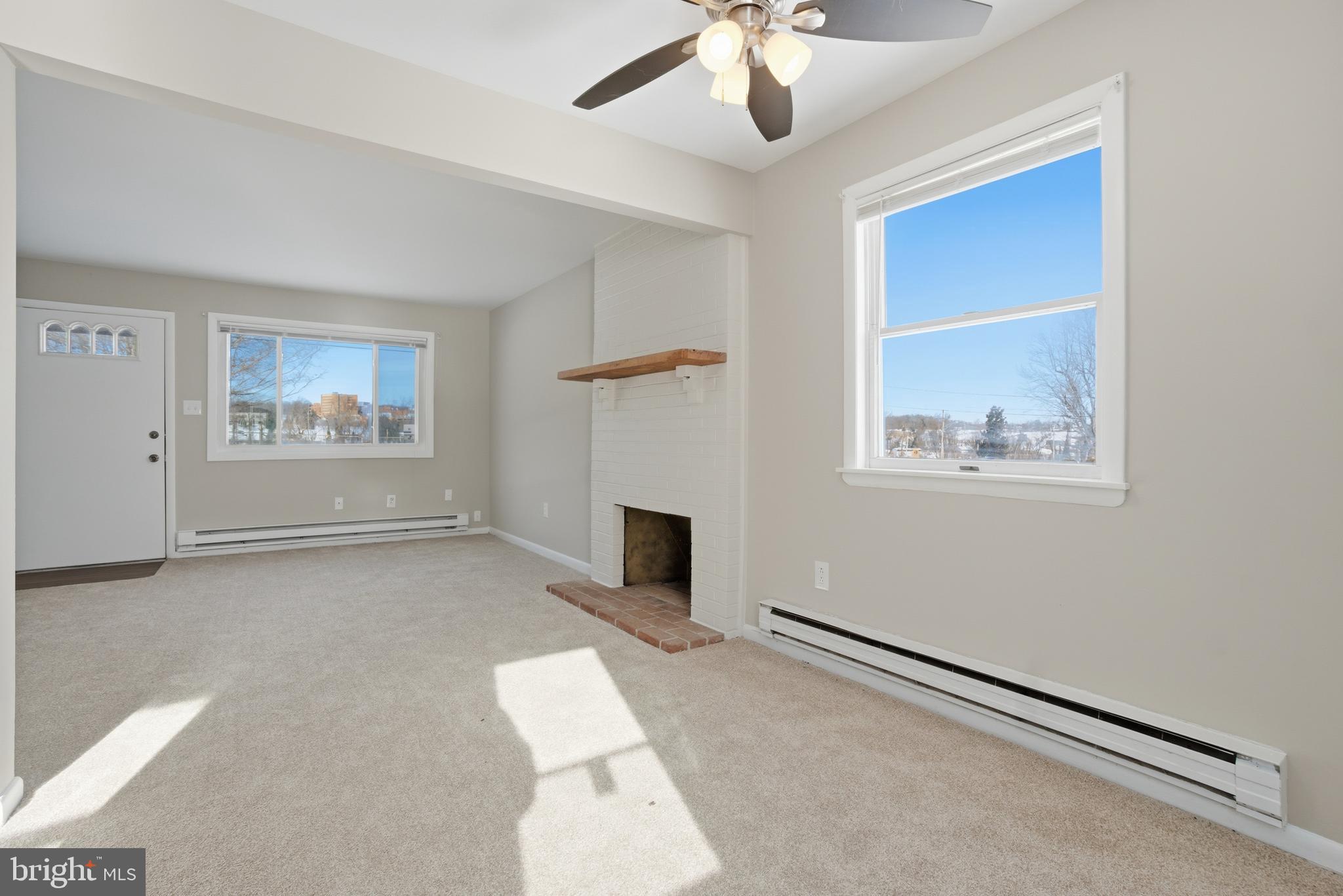 5605 Shelbourne Road, Unit B Baltimore, MD 21227 - Photo 1 of 20 a living room with furniture and a fireplace