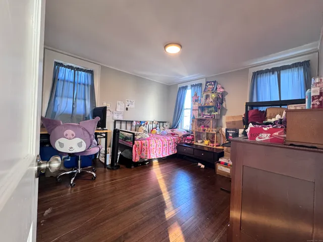 a bed room with furniture and wooden floor