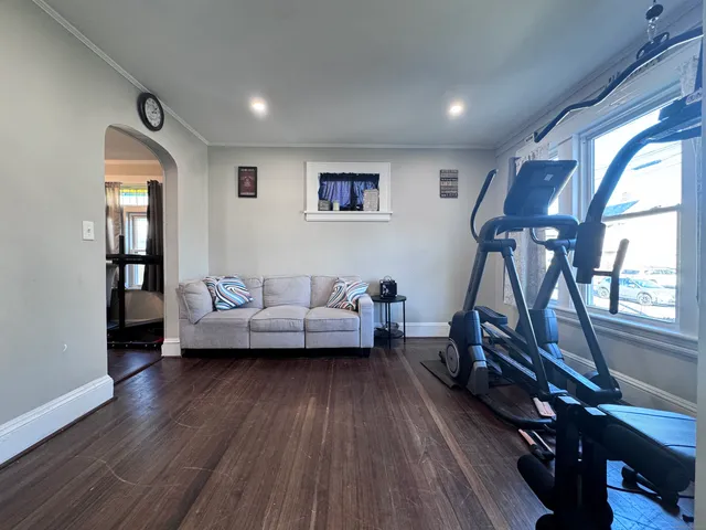 a living room with furniture a window and wooden floor