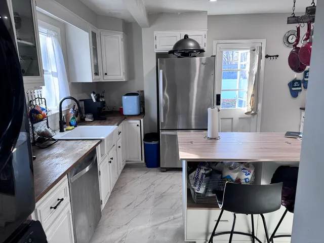 a kitchen with kitchen island a counter top space appliances and cabinets