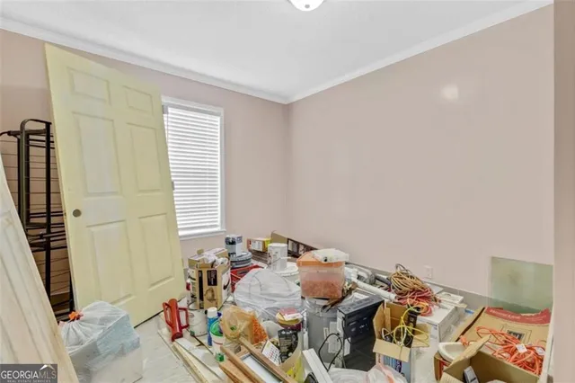 a bed sitting in a bedroom next to a window