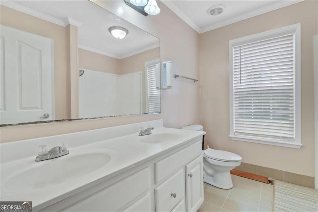 397 Reed Brawner Road Royston, GA 30662 - Photo 17 of 35 a bathroom with a granite countertop sink toilet a large mirror and a window