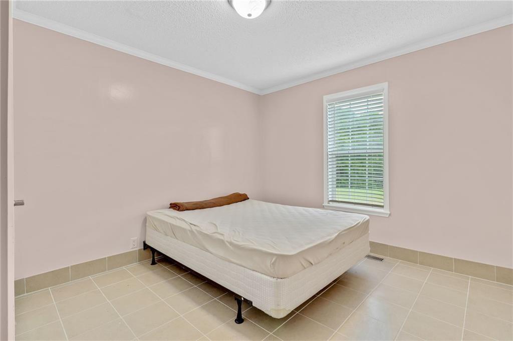 397 Reed Brawner Road Royston, GA 30662 - Photo 18 of 33 a bed sitting in a bedroom next to a window