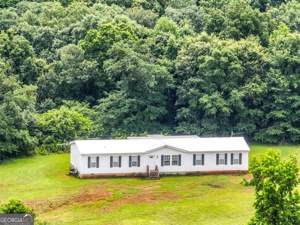 397 Reed Brawner Road Royston, GA 30662 - Photo 3 of 35 a view of a house with swimming pool and garden