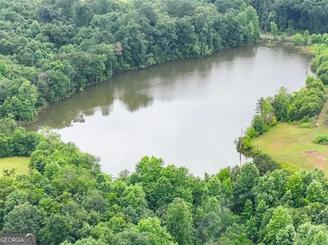 an aerial view of a houses with a lake view