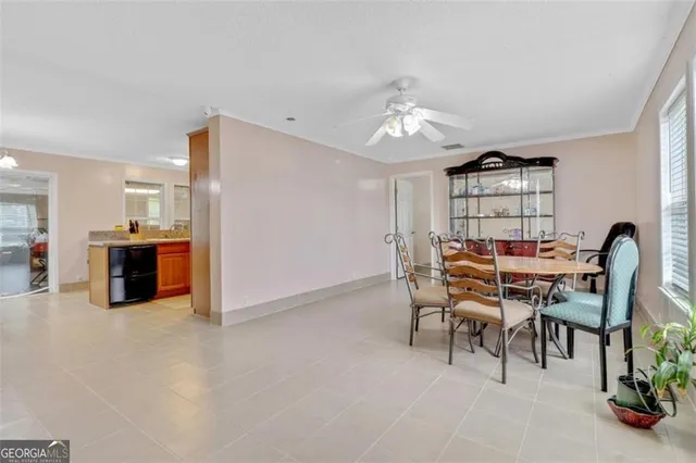 a view of a dining room with furniture and a chandelier