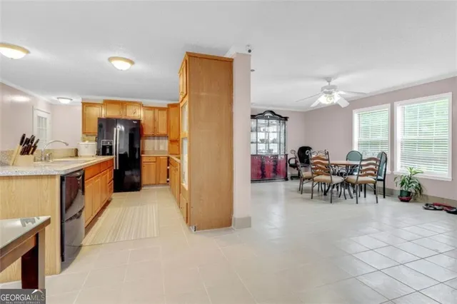 a living room with furniture and a dining table with kitchen view