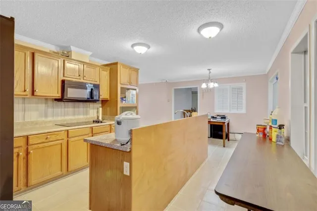 a large white kitchen with lots of counter space and sink