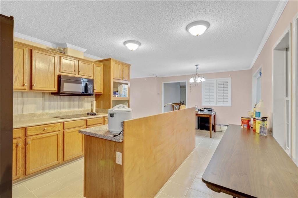 397 Reed Brawner Road Royston, GA 30662 - Photo 9 of 33 a large white kitchen with a large window