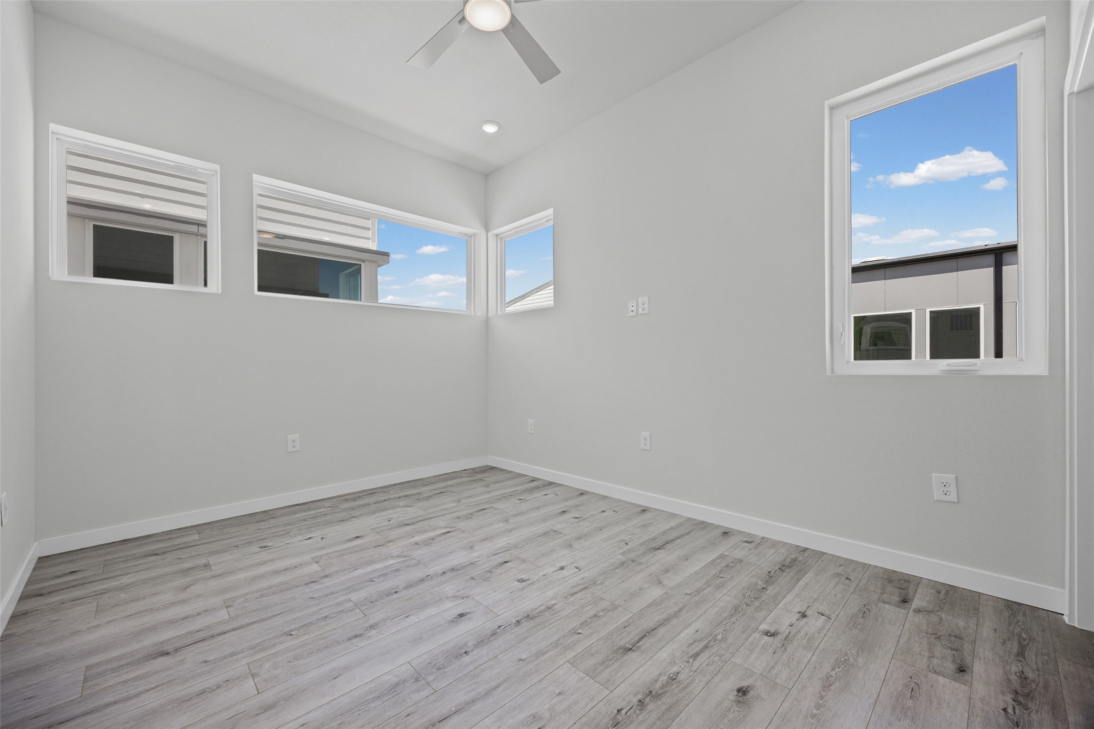 2000 Riverside Farms Road, Unit 5102 Austin, TX 78741 - Photo 19 of 25 Natural light streams into this serene bedroom, showcasing modern flooring and a clean aesthetic.