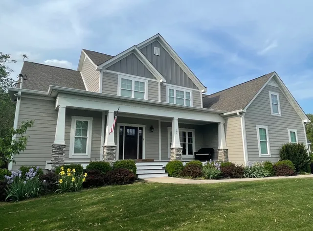 a front view of a house with a yard and garage