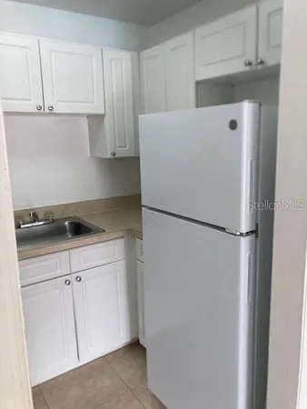 a white refrigerator freezer sitting in a kitchen