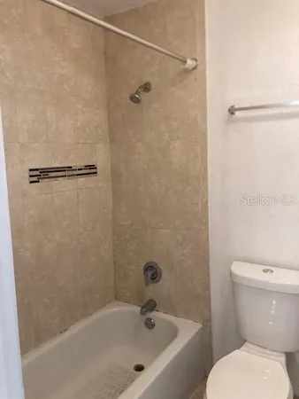 a bathroom with a bathtub and a toilet