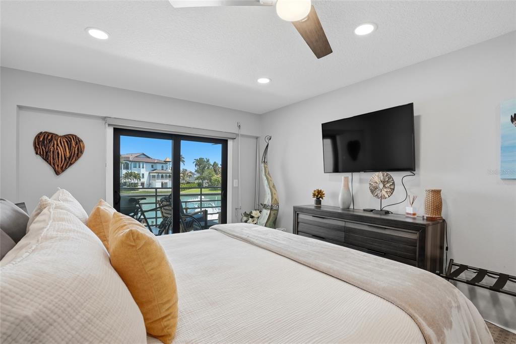 363 Pinellas Bayway South, Unit 29 Tierra Verde, FL 33715 - Photo 22 of 59 a bedroom with a bed and a flat screen tv
