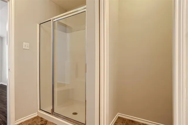 a bathroom with a glass shower door