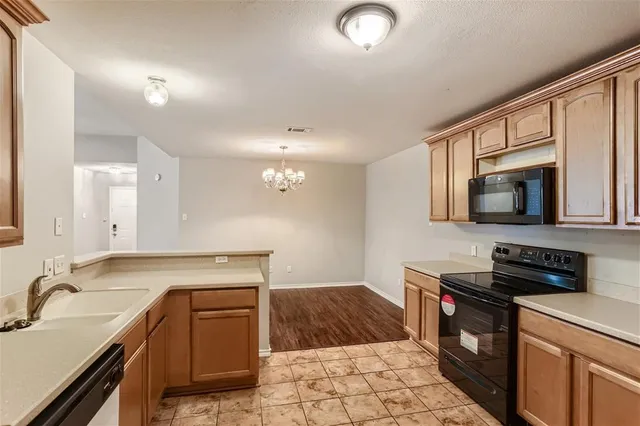 a kitchen with stainless steel appliances granite countertop a sink stove and microwave