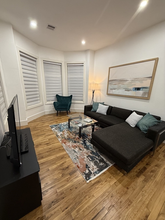 120 Regent Street, Unit 5 Boston, MA 02119 - Photo 17 of 27 a living room with furniture rug and window