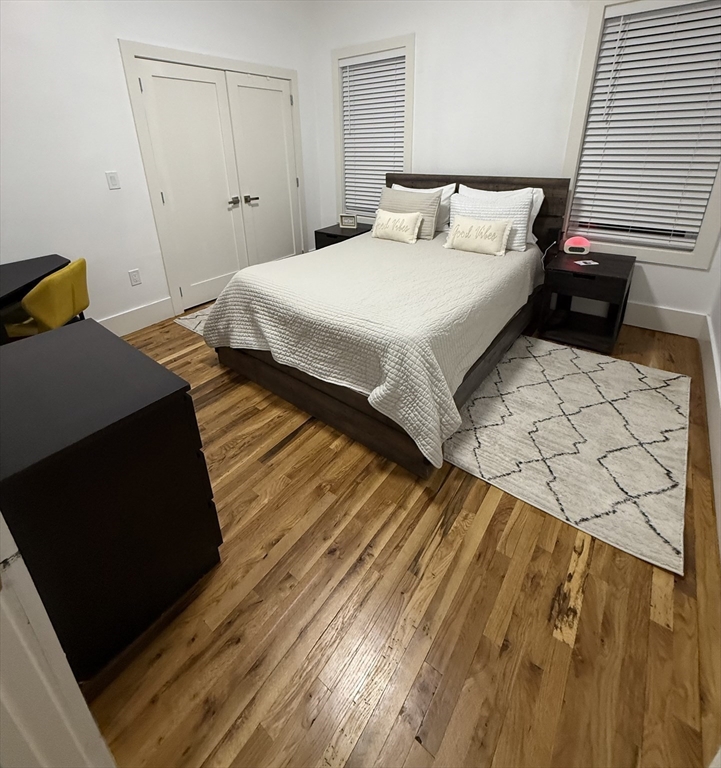 120 Regent Street, Unit 5 Boston, MA 02119 - Photo 21 of 27 a bedroom with a bed and a dresser