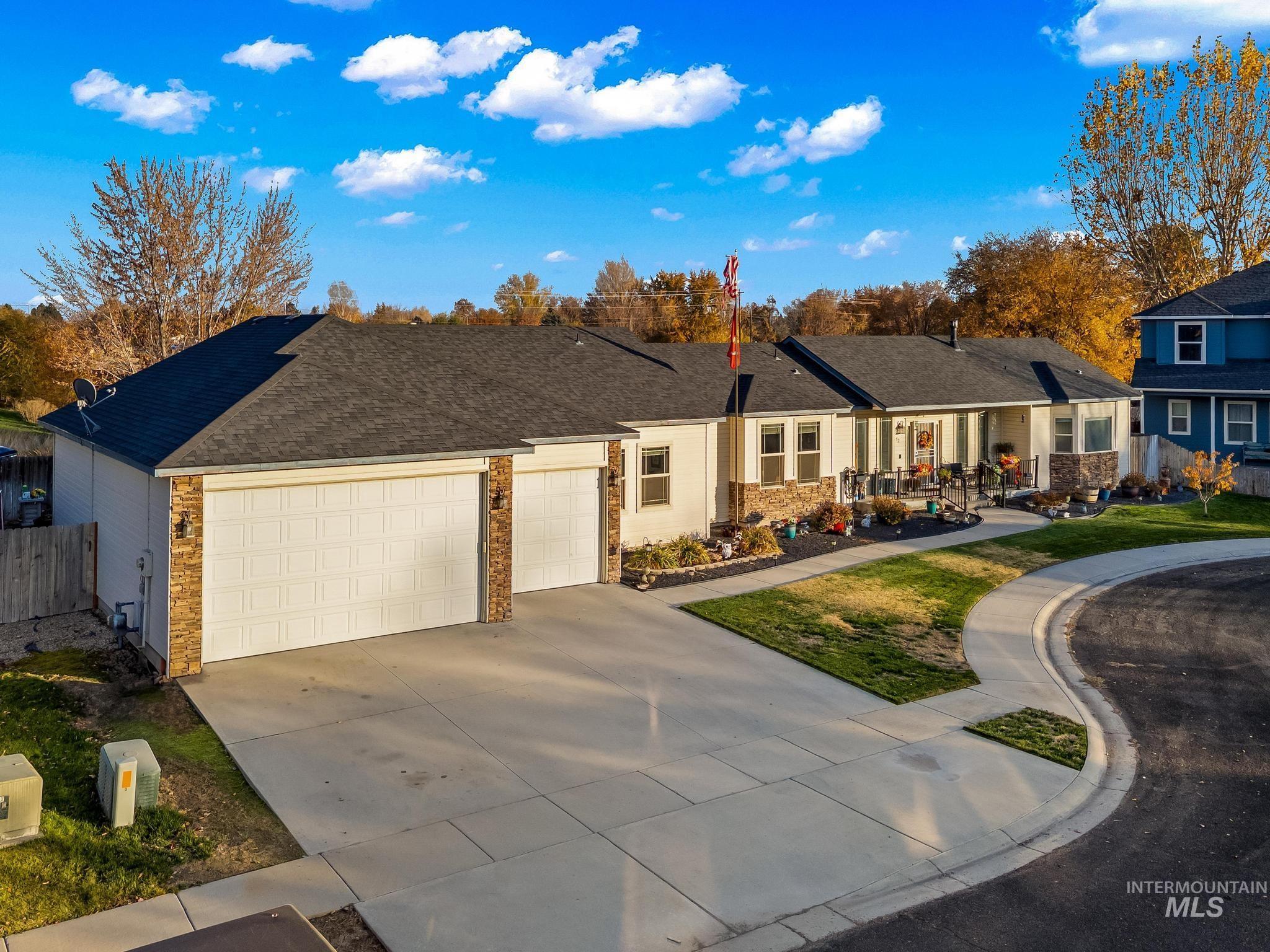 52 Cobblestone Court Middleton, ID 83644 - Photo 1 of 1 Ranch-style home featuring concrete driveway, brick siding, roof with shingles, a garage, and a residential view