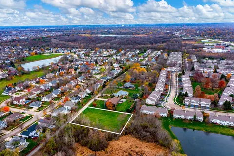 an aerial view of residential houses with outdoor space