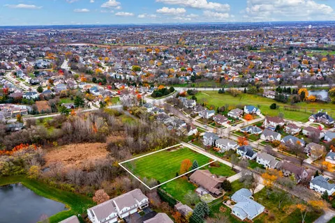 an aerial view of a houses with a lake