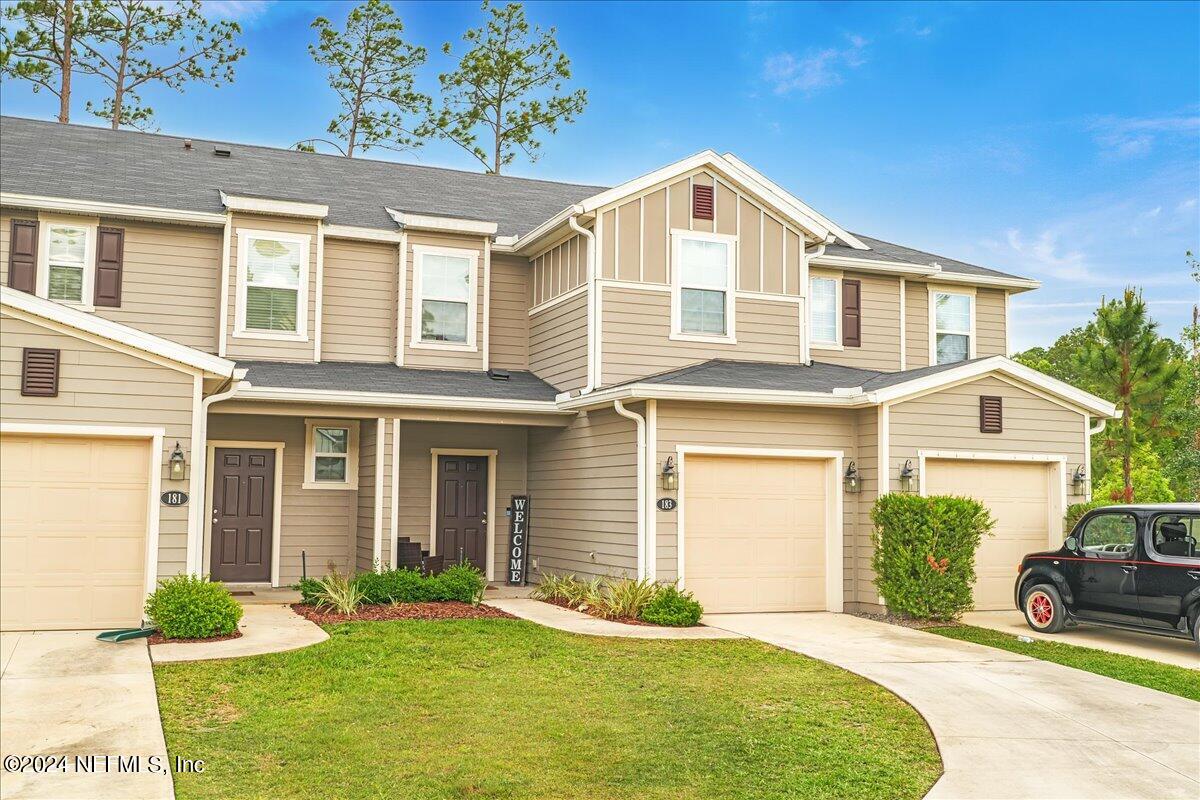 a front view of a house with a yard