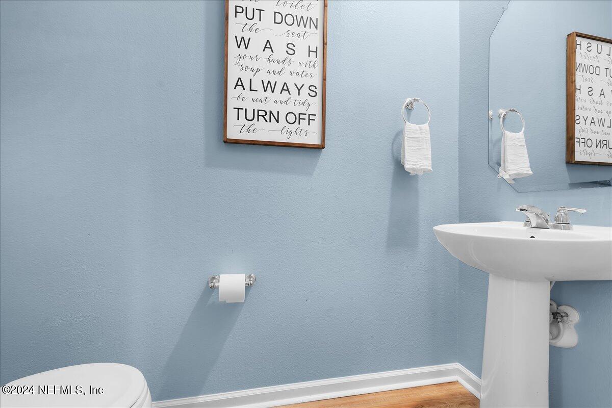 183 Silver Fern Drive St. Augustine, FL 32086 - Photo 14 of 29 a bathroom with a sink a mirror and a toilet