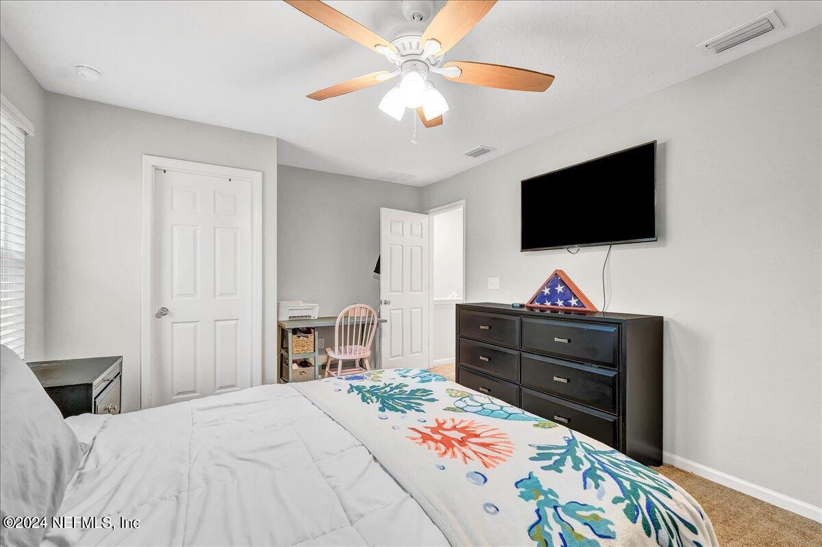 183 Silver Fern Drive St. Augustine, FL 32086 - Photo 19 of 29 a bedroom with a bed and a flat screen tv