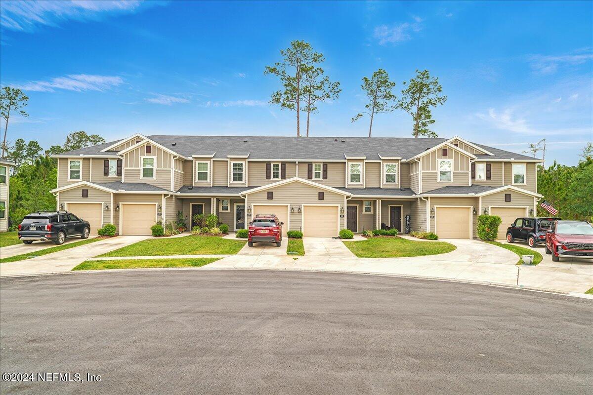 183 Silver Fern Drive St. Augustine, FL 32086 - Photo 2 of 29 a front view of a house with a yard and potted plants