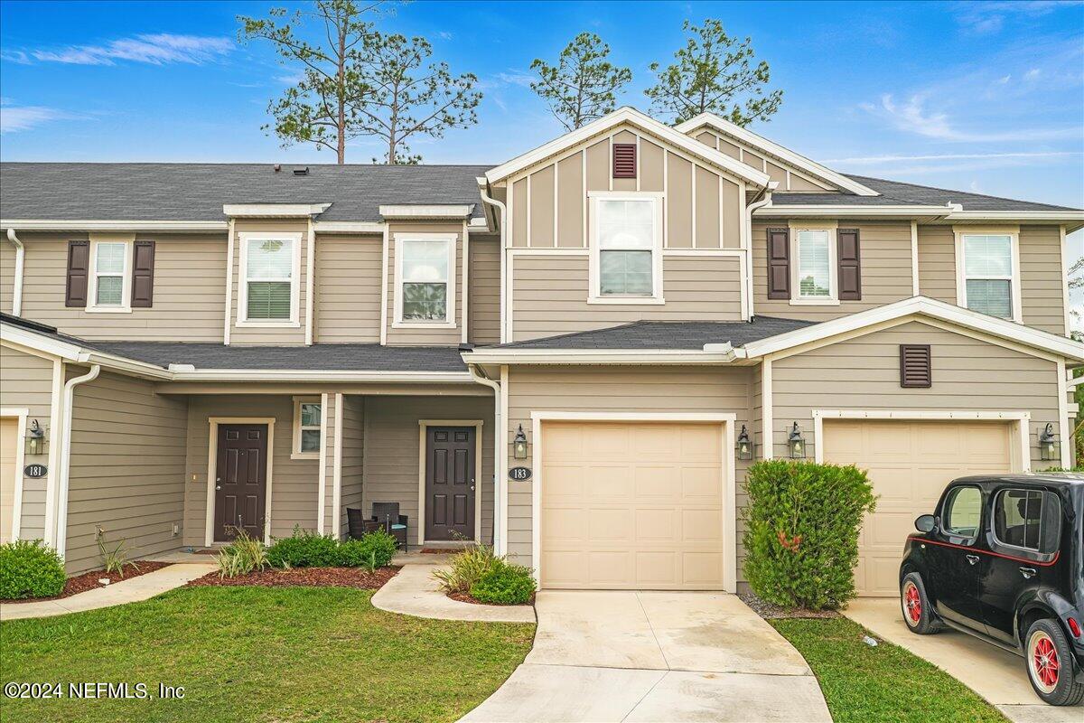 183 Silver Fern Drive St. Augustine, FL 32086 - Photo 28 of 29 a front view of a house with a yard and garage