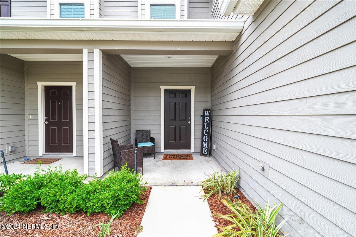 183 Silver Fern Drive St. Augustine, FL 32086 - Photo 3 of 29 a front view of a house with a garden