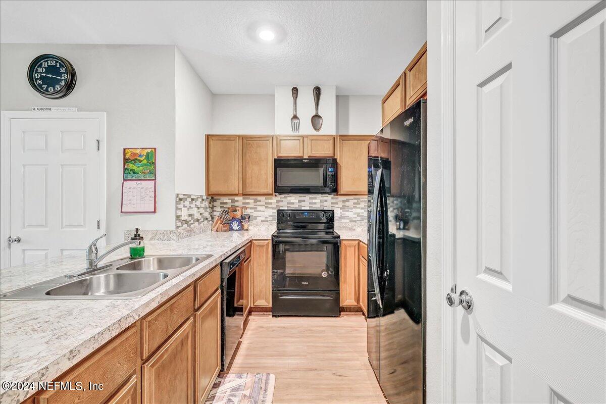 183 Silver Fern Drive St. Augustine, FL 32086 - Photo 6 of 29 a kitchen with stainless steel appliances granite countertop a stove sink and cabinets