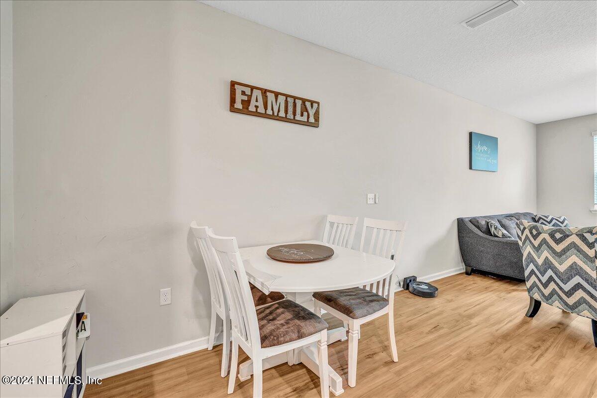 183 Silver Fern Drive St. Augustine, FL 32086 - Photo 8 of 29 a dining room with furniture and wooden floor