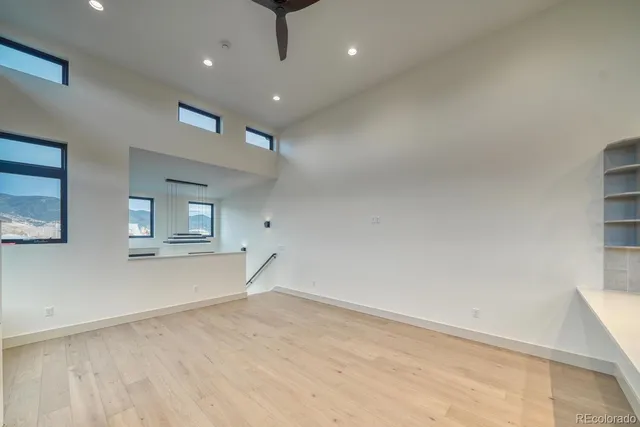 an empty room with a empty space and windows