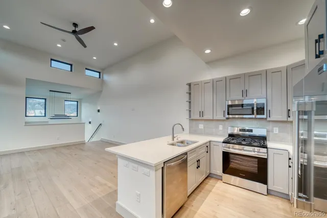 a kitchen with a stove a sink and a refrigerator