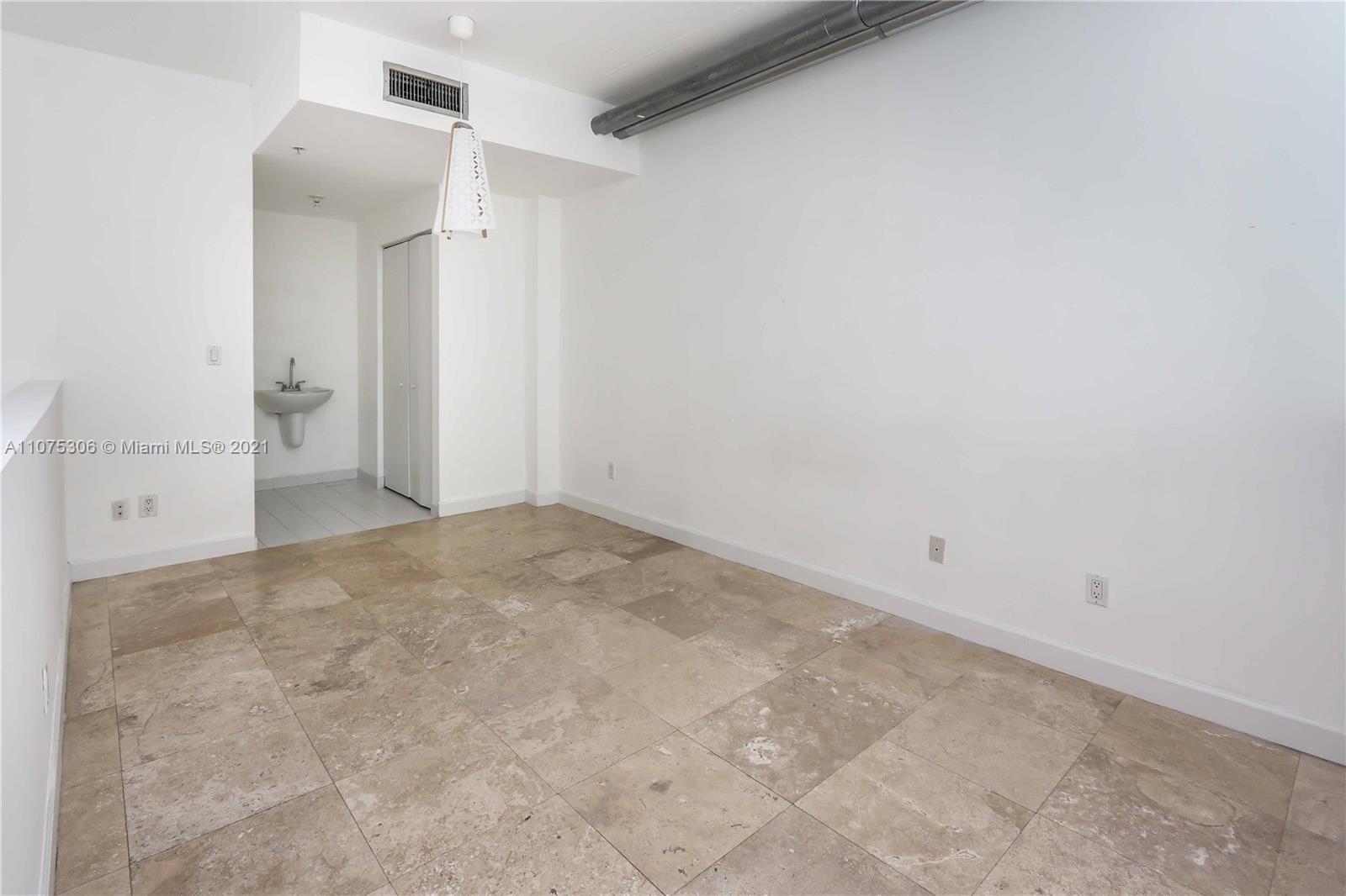 690 Southwest 1st Court, Unit 1715 Miami, FL 33130 - Photo 22 of 42 an empty room with an entrance to other room