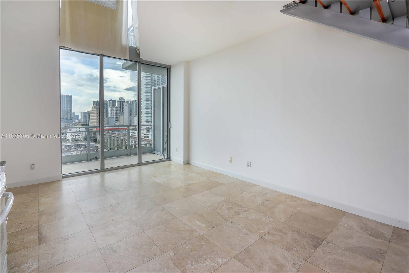 690 Southwest 1st Court, Unit 1715 Miami, FL 33130 - Photo 8 of 42 an empty room with sliding glass door