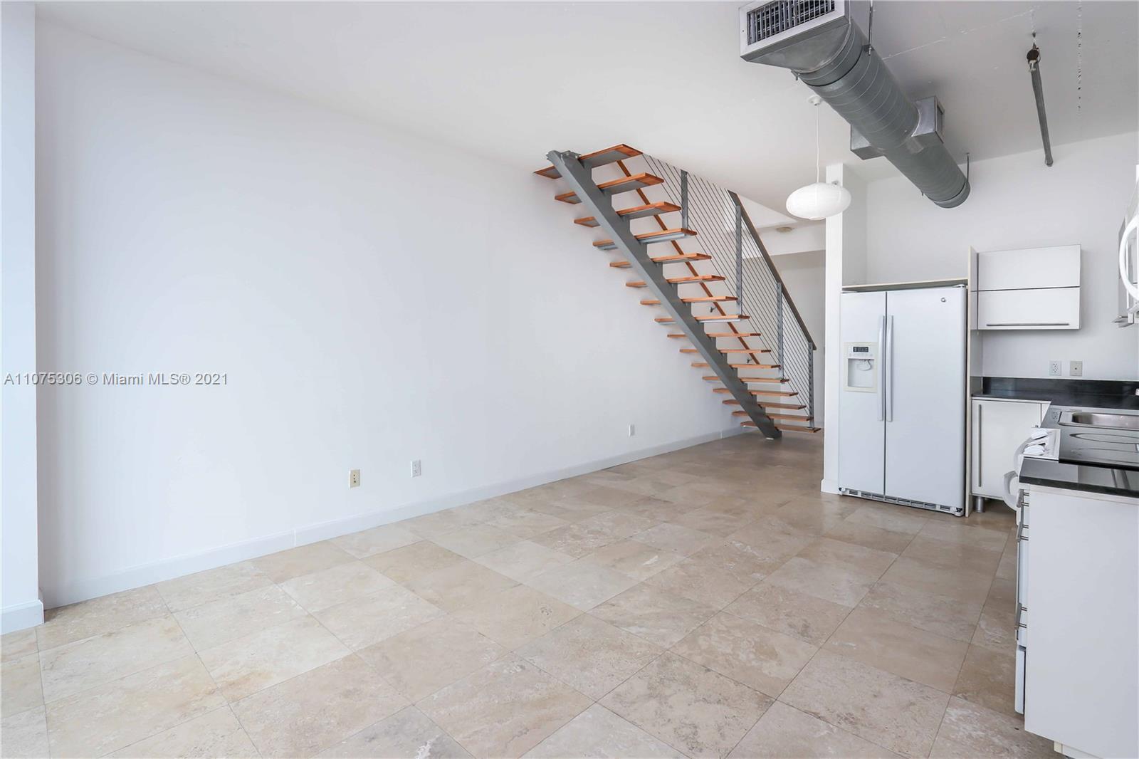690 Southwest 1st Court, Unit 1715 Miami, FL 33130 - Photo 10 of 42 a view of a livingroom with a staircase