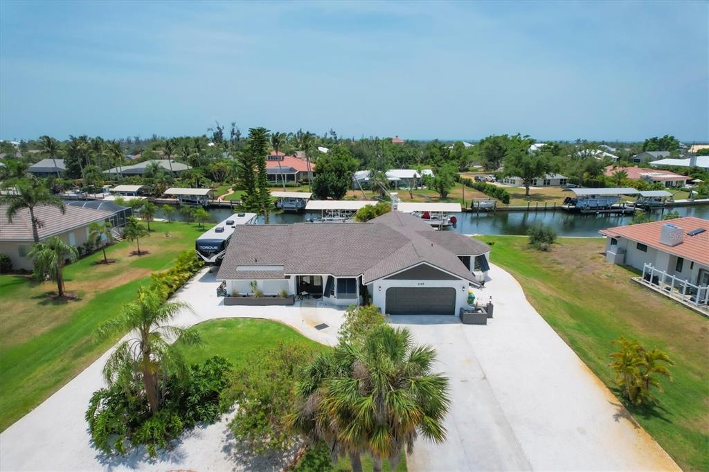 245 Spaniards Road Placida, FL 33946 - Photo 1 of 65 an aerial view of a house with swimming pool and lake view